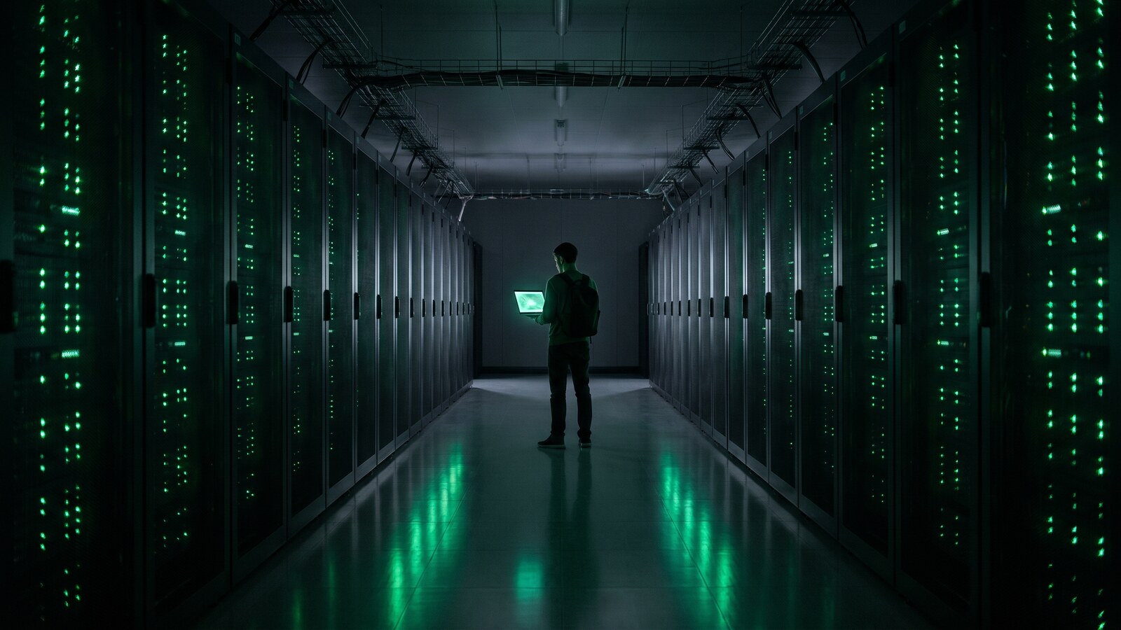 A cloud data centre aisle lit in green
